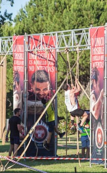Merida, Spain - May 18th, 2024: FarinatoRace Merida 2024. Participants climbing a rope