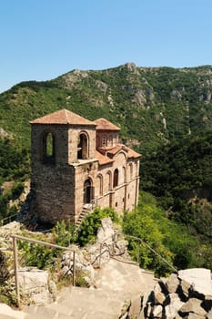 Stairs leading down to the Church of the Holy Mother, part of the medieval Asen's, Asens Fortress, surrounded by mountains and dense, lush vegetation, forest, near Plovdiv, Bulgaria 2022