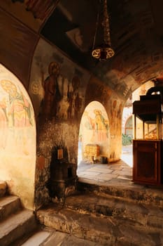 Entrance area of the Church St., Saint Archangels Michael and Gabriel at the Bachkovo Monastery, colorful frescos, paintings cover the ceiling, walls, vaults, close to Plovdiv, Bulgaria 2022