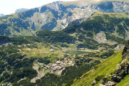 View onto the Fish Lake, Ribnoto Ezero with the Seven Lakes Chalet right next to it at the Seven Rila Lakes Plateau, Rila National Park close to Sofia, Bulgaria 2022