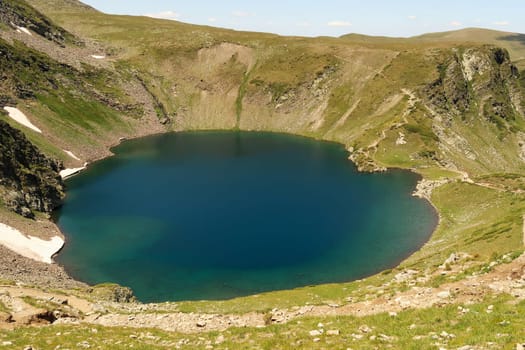 Spectacular view onto the deep blue Eye, Okoto Lake, one of the Seven Rila Lakes, situated on a plateau in the Rila National Park, close to Sofia, Bulgaria 2022