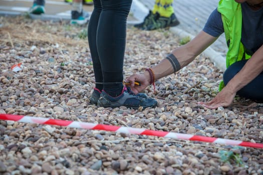 Merida, Spain - May 18th, 2024: FarinatoRace Merida 2024. Assistant cutting the bridle