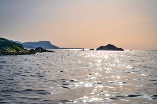 Norwegian fjord landscape. View of the open sea on the Western Cape. Crystal clear water, glistening in the sunshine. Landscape from Scandinavia