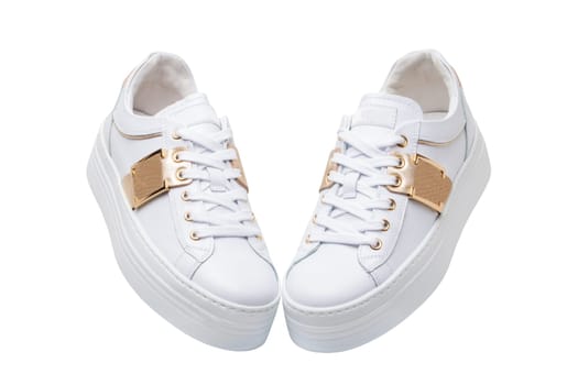 White sneaker isolated. Close-up of a pair white elegant stylish female leather high-heeled sport shoes isolated. Clipping path. Womens shoe fashion. Modern design footwear for workout.