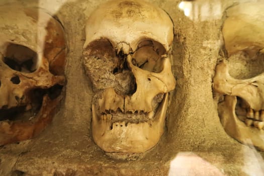 Three remaining skulls in a row in the Skull Tower, a stone structure in which hundreds of human skulls were embedded by the soldiers of the Ottoman Empire, Nis, Serbia 2022