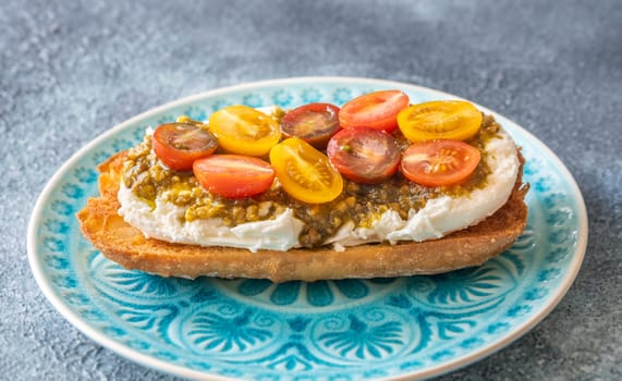 Bruschetta with burrata cheese, pesto and tomatoes