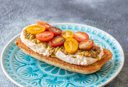 Bruschetta with burrata cheese, pesto and tomatoes