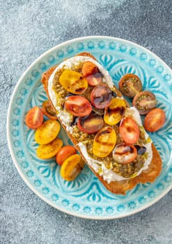 Bruschetta with burrata cheese, pesto and tomatoes