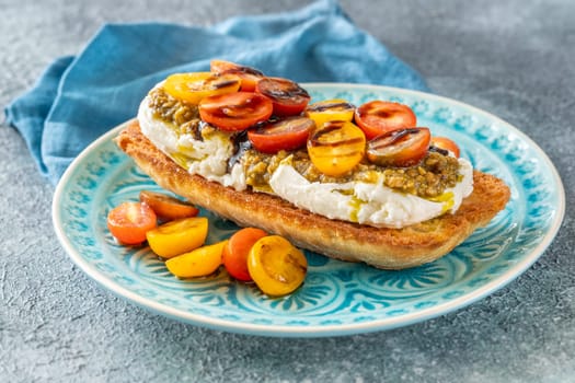 Bruschetta with burrata cheese, pesto and tomatoes