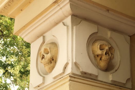 Two skull carvings, sculptures, reliefs on a pillar, column, facade of the chapel around the Skull Tower, a stone structure in which hundreds of human skulls were embedded by the soldiers of the Ottoman Empire, Nis, Serbia 2022