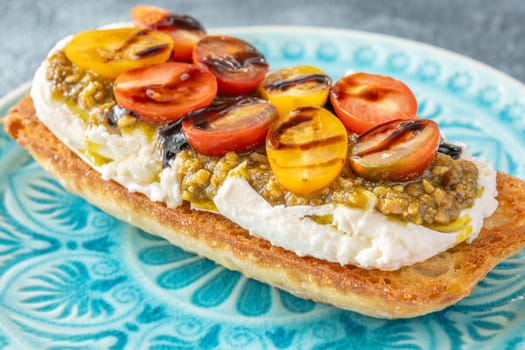 Bruschetta with burrata cheese, pesto and tomatoes