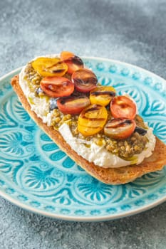 Bruschetta with burrata cheese, pesto and tomatoes