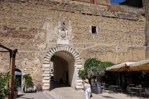 Pitigliano, Italy - September 13, 2022: Entrance gate to the historic center of Pitigliano - the picturesque medieval town founded in Etruscan time on the tuff hill in Tuscany, Italy.