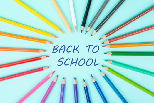 Color pencils collection in a row, back to school, drawing supplies, blue background with copy space
