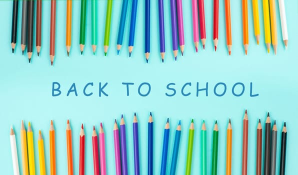 Color pencils collection in a row, back to school, drawing supplies, blue background with copy space