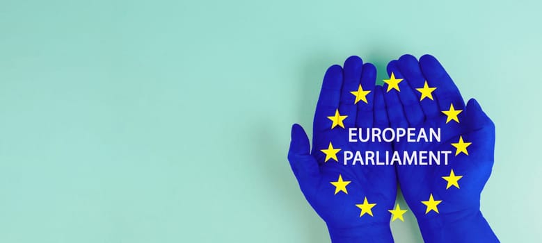 EU election, hand with european union flag, blue and yellow stars, citizens of Europe voting Parliament
