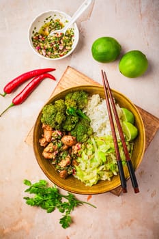 Chicken bowl with rice, broccoli, cabbage and green Chimmichurri salsa