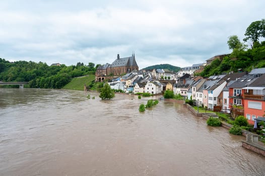 Flood of the river Saar, Saarburg in Saarland, Germany, flooded trees and paths, high water level, climate change