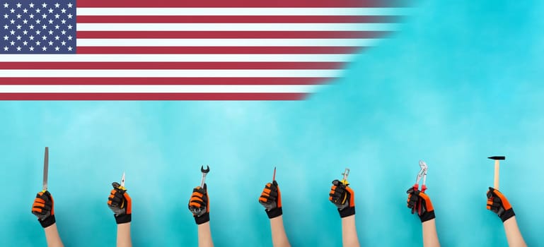 Craftsman or handyman with different tools in the hand, labor day, american flag, craft and apprentice, hammer, pliers and wrech