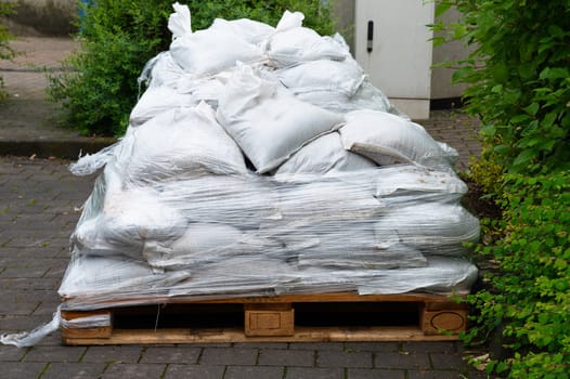 Sandbags for flood defense, river Moselle Trier in Rhineland Palatinate, flooded trees and paths, high water level, climate change