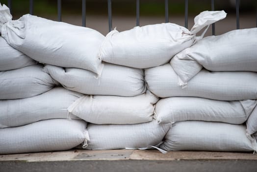 Sandbags for flood defense, river Moselle Trier in Rhineland Palatinate, flooded trees and paths, high water level, climate change