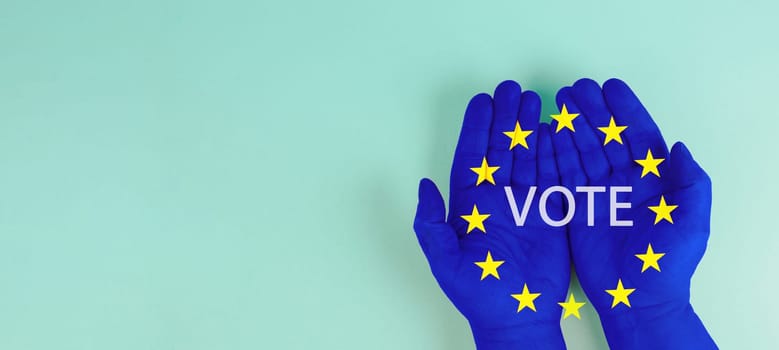 EU election, hand with european union flag, blue and yellow stars, citizens of Europe voting Parliament
