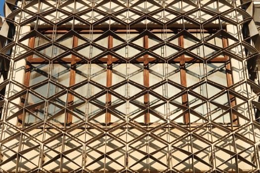 A window of the National University Library of Kosovo, covered by a metal grid, net, an example of socialist, brutalist architecture in the city center of Prishtina, Pristina, Kosovo 2022