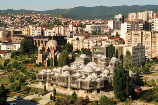 Spectacular view from the bell, clock tower of the Cathedral of Saint, St. Mother Theresa onto the National University Library of Kosovo, an example of brutalist, socialist architecture in the city center of Prishtina, Pristina, Kosovo 2022