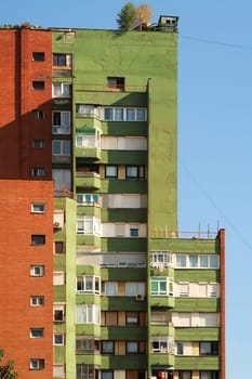 A colorful, orange and green socialist, brutalist concrete panel, multi-story, high-rise, apartment block, building in the city center of Prishtina, Pristina, Kosovo 2022