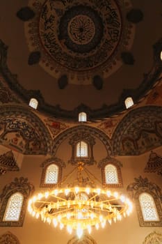 Chandelier and elaborate ceiling decoration, pattern, painting, fresco inside the Sinan Pasha Mosque, an ottoman mosque in the old town of Prizren, Kosovo 2022