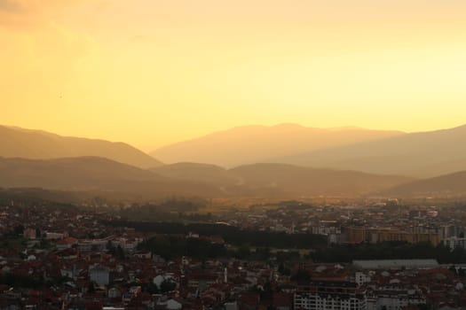 View from the Prizren Fortress onto the city and its surrounding landscape at sunset, the highway road can be seen in the far distance, Prizren, Kosovo 2022
