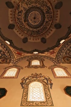 Elaborate painting, fresco, decoration, pattern, ornament on the ceiling, wall and around the windows inside the ottoman Sinan Pasha Mosque in the old town of Prizren, Kosovo 2022