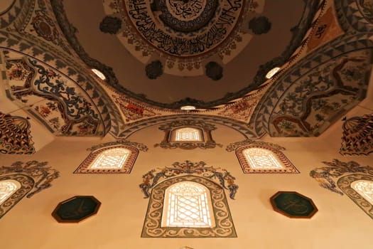 Elaborate painting, fresco, decoration, pattern, ornament on the ceiling, wall and around the windows inside the Sinan Pasha Mosque, an ottoman mosque in the old town of Prizren, Kosovo 2022