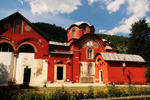 The bright red Church Complex inside the courtyard, garden of the Patriarchate of Pec Monastery, outside of Peja, Kosovo 2022