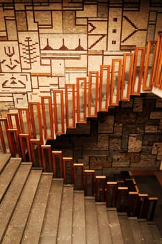 The stairs, staircase, hallway with wooden rails, handrails, railings in front of a patterned wall inside the National University Library of Kosovo, Prishtina, Pristina, Kosovo, 25th of July 2022