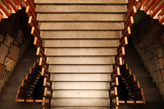 Looking down onto the stairs, staircase, hallway with wooden rails, handrails, railings inside the National University Library of Kosovo, Prishtina, Pristina, Kosovo, 25th of July 2022