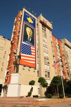 The famous Bill Clinton Statue in front of a big Bill Clinton Banner and next to an american flag on Bill Clinton Boulevard, Prishtina, Pristina, Kosovo, 25th of July 2022