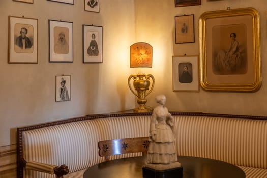 Masino, Italy - 12 December 2023: old apartment interior, early 20th century furniture, living room, nobody