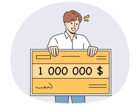 Happy man holding million dollar certificate rejoicing in winning lottery or casino. Lucky young guy with giant check for million dollars smiles after winning cash prize in competition.