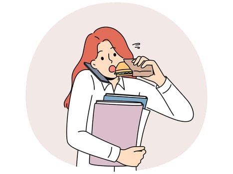 Busy multitasking woman answers phone biting on sandwich to save time at lunch. Young businesswoman with folders in hands eats and works in multitasking mode, wishing to succeed in career