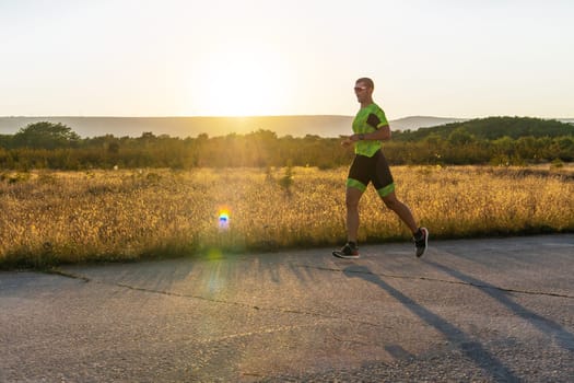 Triathlete in professional gear running early in the morning, preparing for a marathon, dedication to sport and readiness to take on the challenges of a marathon