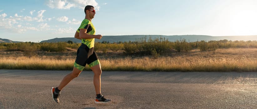 Triathlete in professional gear running early in the morning, preparing for a marathon, dedication to sport and readiness to take on the challenges of a marathon
