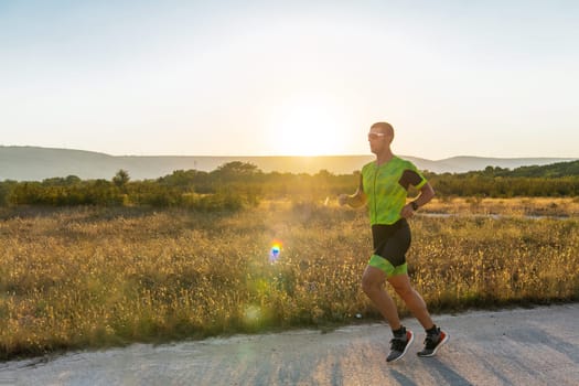 Triathlete in professional gear running early in the morning, preparing for a marathon, dedication to sport and readiness to take on the challenges of a marathon