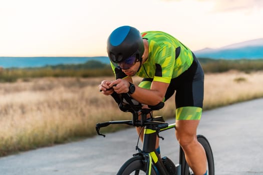 Triathlete riding his bicycle during sunset, preparing for a marathon. The warm colors of the sky provide a beautiful backdrop for his determined and focused effort