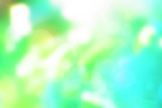 Abstract gradient light blue turquoise yellow green shiny blurred background texture with circular bokeh lights. Beautiful fresh backdrop. Space for design.
