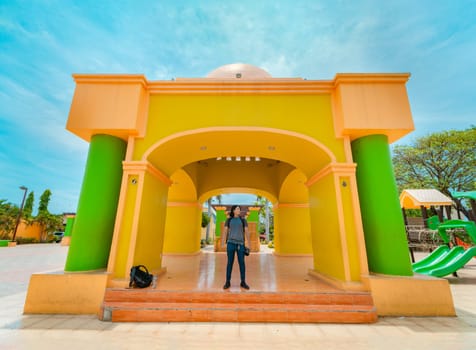Young tourist in the central park of Nagarote, Nicaragua. Portrait of tourist at the colorful monument of Nagarote park