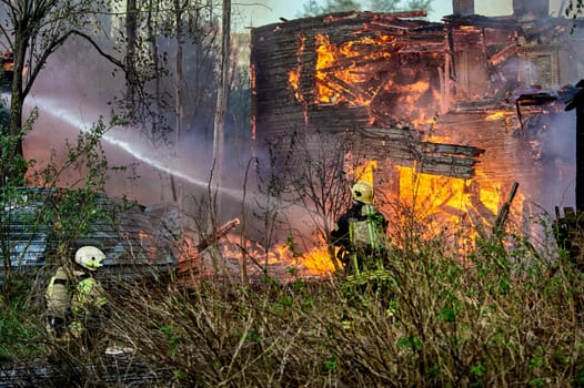 extinguishing the fire of a wooden house. High quality photo