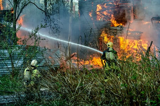 extinguishing the fire of a wooden house. High quality photo