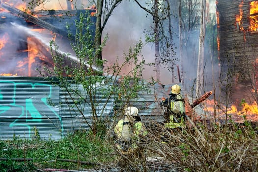 extinguishing the fire of a wooden house. High quality photo