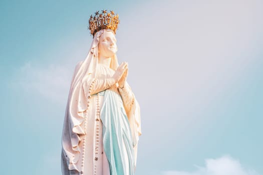 Lourdes, France - August 28, 2021: Sculpture of the crowned Virgin Mary in the Sanctuary of Lourdes in France. Place of worship and pilgrimage for christians